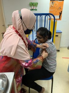 Student receives vaccine dosage